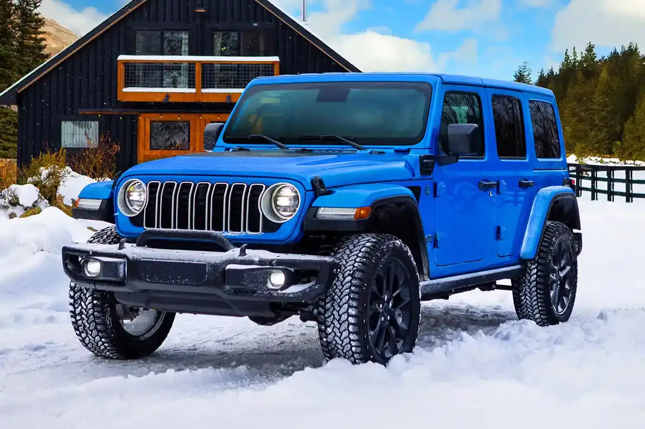 Jeep 2025 Jeep Wrangler 4xe Backcountry in profile view, showing black exterior decals, 20-inch wheels with all-terrain tires, steel bumpers, and rock rails against a natural outdoor background.