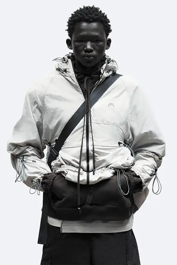 RADIO ECHOES: A-COLD-WALL* TUNES INTO UK ROOTS FOR SS25 pic of A-COLD-WALL*'s Spring/Summer 2025 collection called "Pink Noise," which draws inspiration from British radio culture. The piece describes the collection's technical outerwear, including utility jackets with toggles and drawstrings, ice blue collared jackets paired with loose shirts, color-blocked knitwear in black, brown and cream, graphic t-shirts, ribbed vests, and practical sling bags. The article notes that this collection follows the departure of founder Samuel Ross and the brand's acquisition by Four Marketing. The collection maintains A-COLD-WALL*'s signature gorpcore aesthetic with functional designs and is currently available on the brand's website. (image 9 of 9)