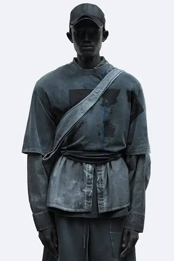RADIO ECHOES: A-COLD-WALL* TUNES INTO UK ROOTS FOR SS25 pic of A-COLD-WALL*'s Spring/Summer 2025 collection called "Pink Noise," which draws inspiration from British radio culture. The piece describes the collection's technical outerwear, including utility jackets with toggles and drawstrings, ice blue collared jackets paired with loose shirts, color-blocked knitwear in black, brown and cream, graphic t-shirts, ribbed vests, and practical sling bags. The article notes that this collection follows the departure of founder Samuel Ross and the brand's acquisition by Four Marketing. The collection maintains A-COLD-WALL*'s signature gorpcore aesthetic with functional designs and is currently available on the brand's website. (image 6 of 9)