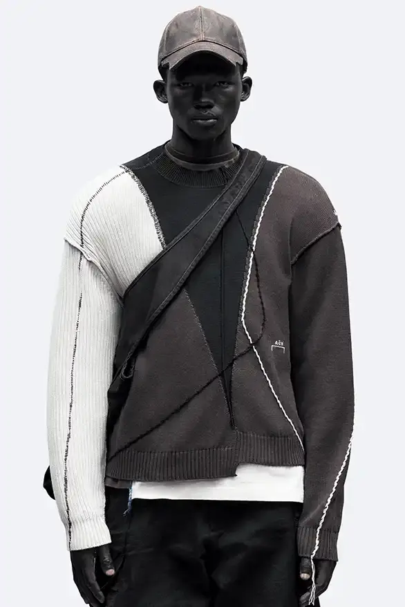 RADIO ECHOES: A-COLD-WALL* TUNES INTO UK ROOTS FOR SS25 pic of A-COLD-WALL*'s Spring/Summer 2025 collection called "Pink Noise," which draws inspiration from British radio culture. The piece describes the collection's technical outerwear, including utility jackets with toggles and drawstrings, ice blue collared jackets paired with loose shirts, color-blocked knitwear in black, brown and cream, graphic t-shirts, ribbed vests, and practical sling bags. The article notes that this collection follows the departure of founder Samuel Ross and the brand's acquisition by Four Marketing. The collection maintains A-COLD-WALL*'s signature gorpcore aesthetic with functional designs and is currently available on the brand's website. (image 8 of 9)