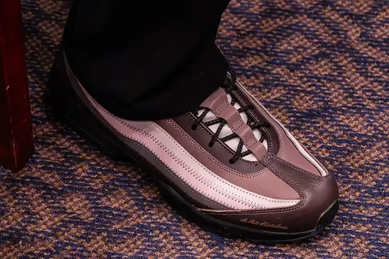 Side view of the A Ma Maniére x Air Max 95 displaying the distinctive layered design in purple and pink tones, with A Ma Maniére script branding visible on the toe