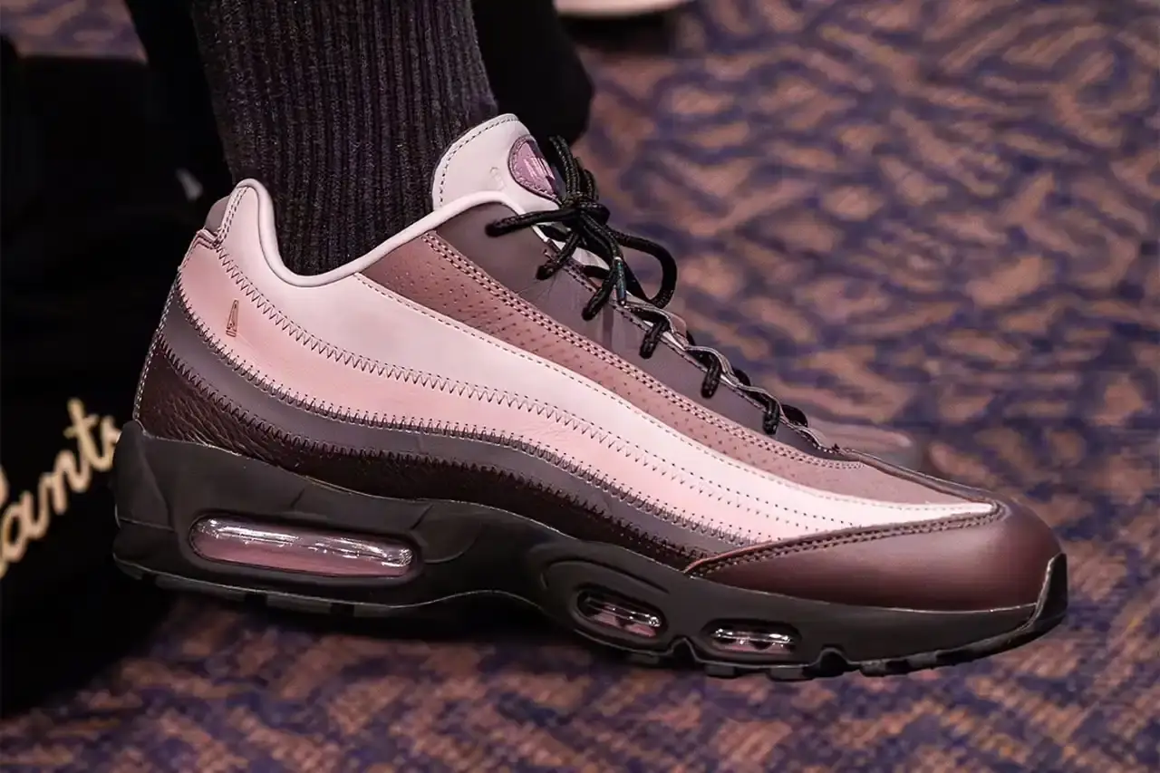 A Ma Maniére x Nike Air Max 95 'W.Y.W.S.' sneaker in Dark Violet Ore and Burgundy Ash colorway, showcasing the layered side profile with gradient panels and visible Air unit