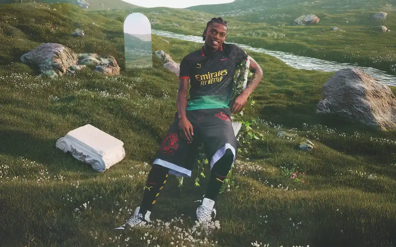 AC Milan rafael leao AC Milan's 2025 fourth kit collaboration with PUMA and Off-White™, showing two versions: a black to power green gradient jersey with yellow logos and red accents, and an alternate red to power green gradient jersey with monochromatic club crest and yellow details. Both feature Off-White™'s signature design elements including quotation marks and zip ties. The shirts display the 'Diavoli' nickname on the chest and incorporate a modified arrow pattern throughout.