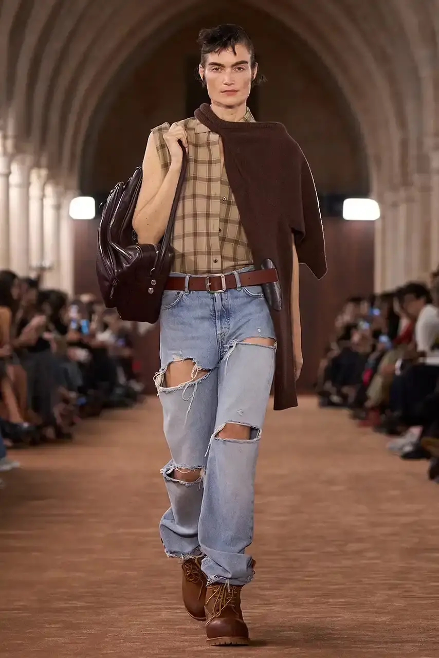 ACNE STUDIOS AND TIMBERLAND COLLABORATE ON 6-INCH BOOT Acne Studios presented a collaborative 6-Inch boot with Timberland during its Spring/Summer 2026 Paris Fashion Week runway show. The boot features washed brown tones and minimal design changes.