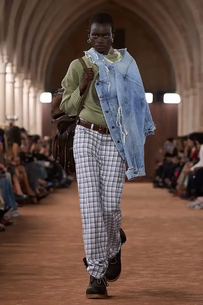 ACNE STUDIOS AND TIMBERLAND COLLABORATE ON 6-INCH BOOT Acne Studios presented a collaborative 6-Inch boot with Timberland during its Spring/Summer 2026 Paris Fashion Week runway show. The boot features washed brown tones and minimal design changes. (image 2 of 3)