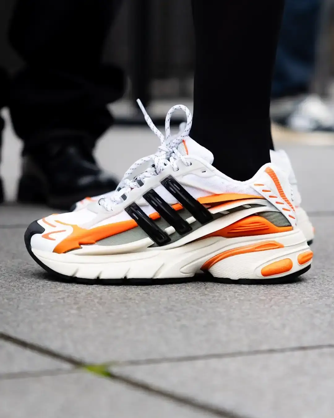 Adidas x Pharrell Williams Jellyfish sneaker featuring a multi-layered upper design with oversized overlays, sporty silhouette, and 'VIRGINIA' text on the tongue, shown in one of two colorways spotted during Paris Fashion Week.