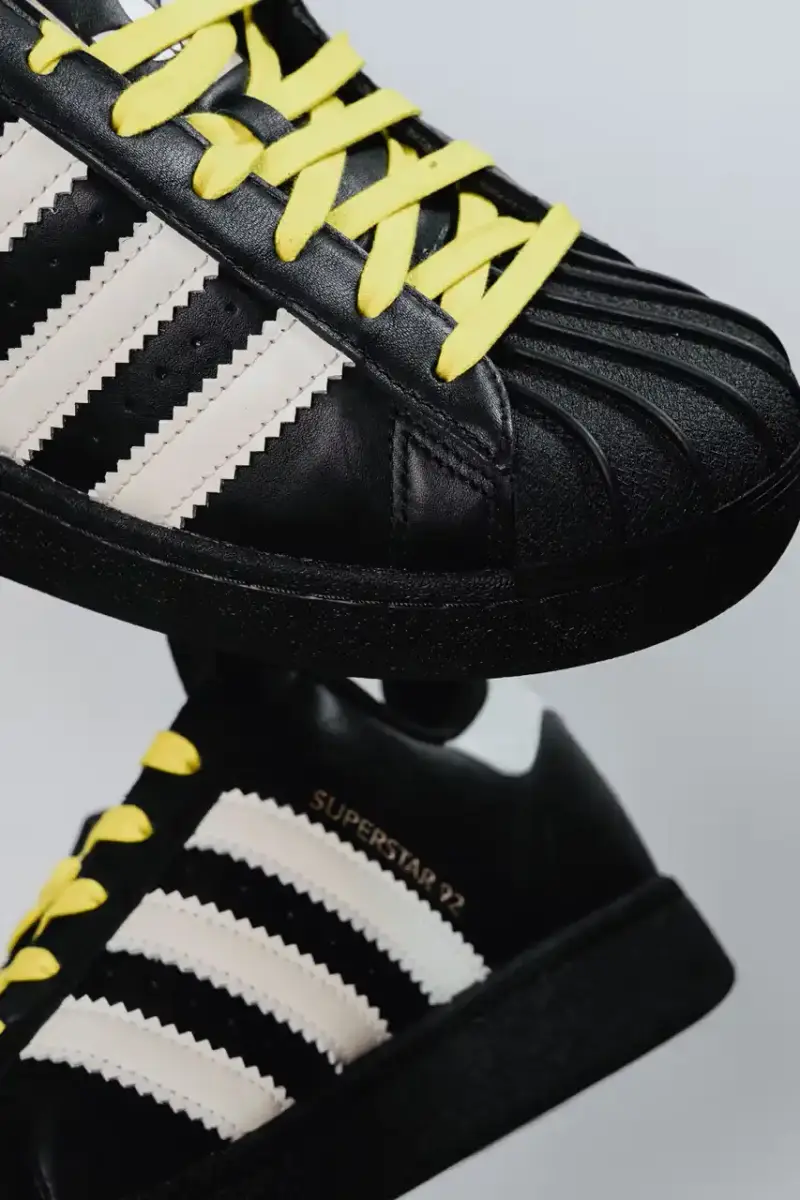 A Ma Maniére The Pharrell x adidas Virginia Superstar 92 sneaker in Off White colorway, showing its oversized silhouette with thick padding and classic shell toe design against a neutral background. (image 6 of 6)