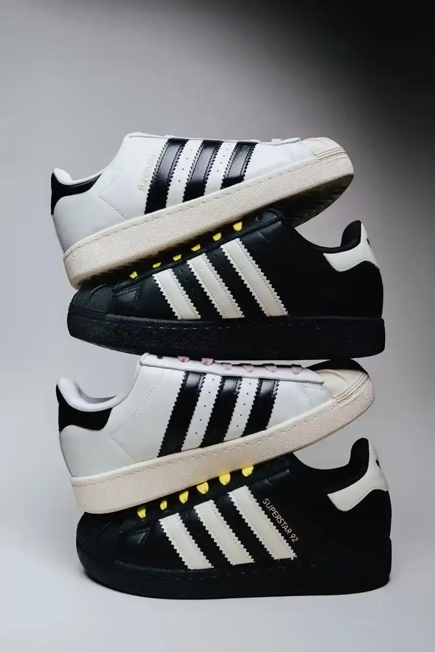 A Ma Maniére The Pharrell x adidas Virginia Superstar 92 sneaker in Off White colorway, showing its oversized silhouette with thick padding and classic shell toe design against a neutral background.