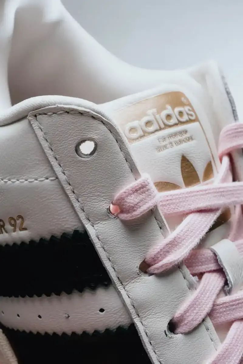 A Ma Maniére The Pharrell x adidas Virginia Superstar 92 sneaker in Off White colorway, showing its oversized silhouette with thick padding and classic shell toe design against a neutral background. (image 4 of 6)