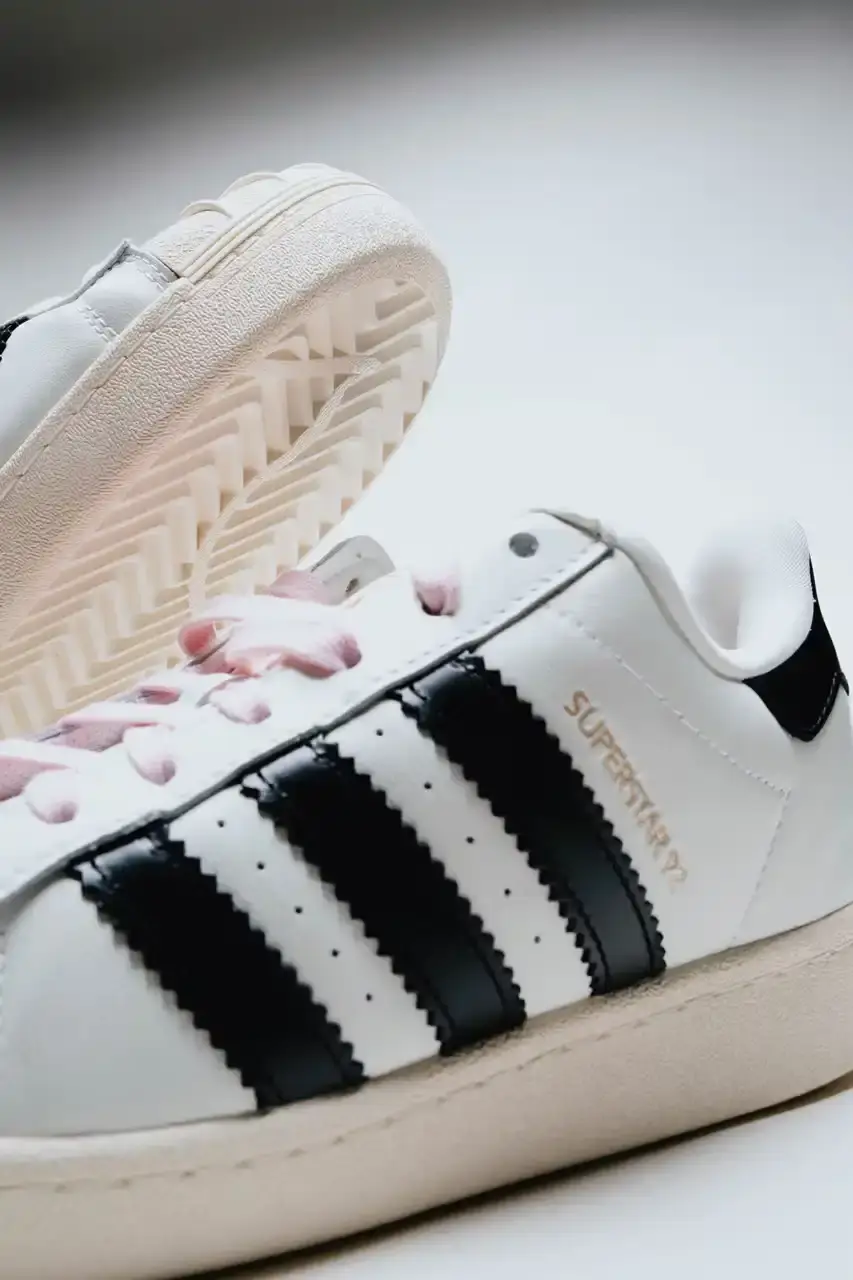 A Ma Maniére The Pharrell x adidas Virginia Superstar 92 sneaker in Off White colorway, showing its oversized silhouette with thick padding and classic shell toe design against a neutral background. (image 3 of 6)