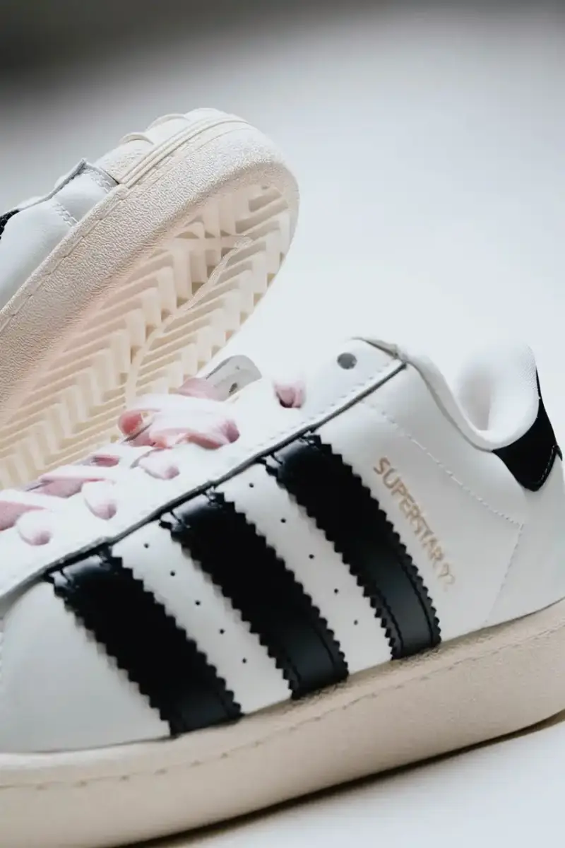 A Ma Maniére The Pharrell x adidas Virginia Superstar 92 sneaker in Off White colorway, showing its oversized silhouette with thick padding and classic shell toe design against a neutral background. (image 3 of 6)