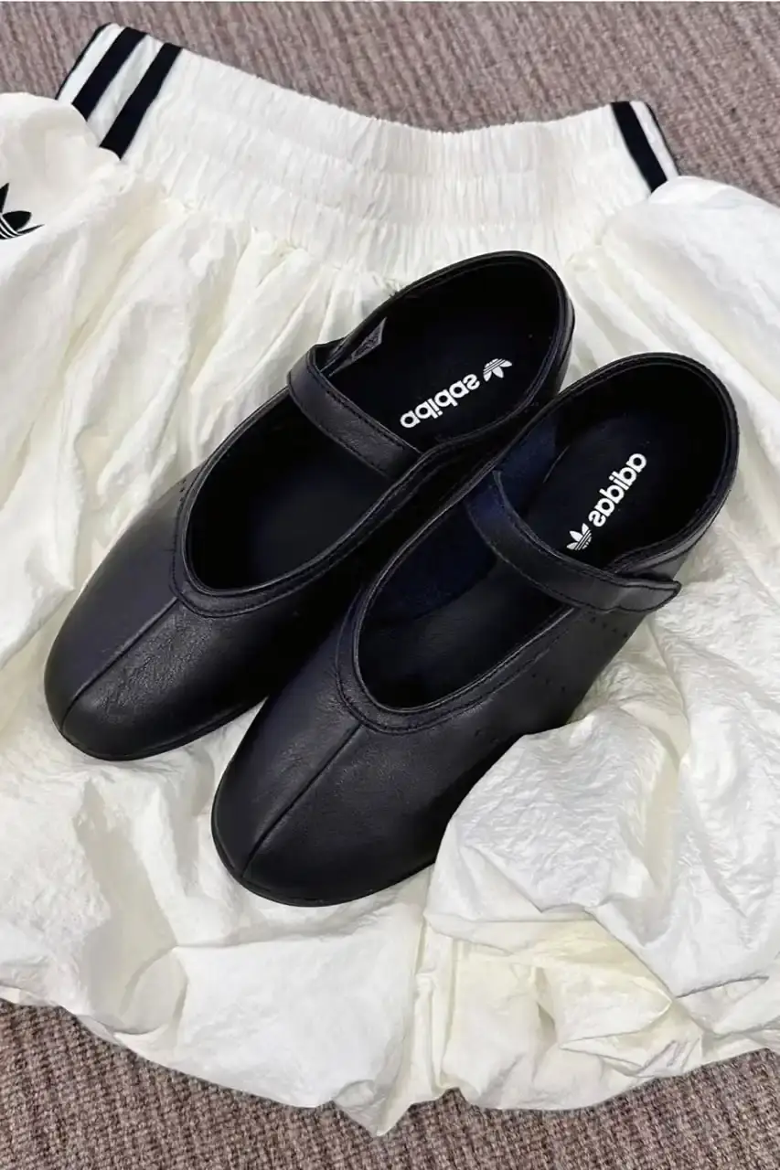 ADIDAS STAN SMITH BALLET FEATURES MINIMAL FLAT DESIGN image about leaked photographs of upcoming adidas Stan Smith Ballet shoe featuring flat sole construction, minimalist design elements, single leather strap closure system, and expected summer 2025 release in black and white colorway options. (image 1 of 5)