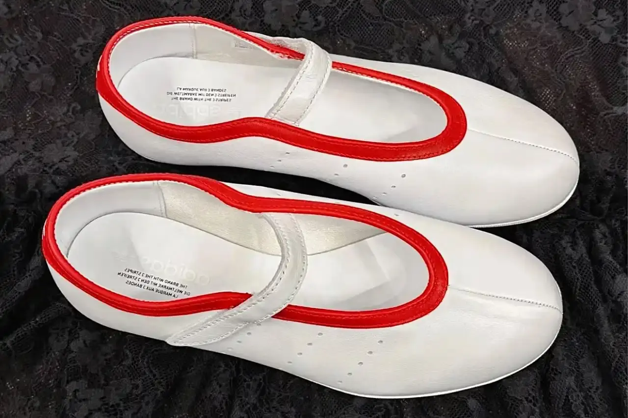 image about leaked photographs of upcoming adidas Stan Smith Ballet shoe featuring flat sole construction, minimalist design elements, single leather strap closure system, and expected summer 2025 release in black and white colorway options. (image 2 of 2)