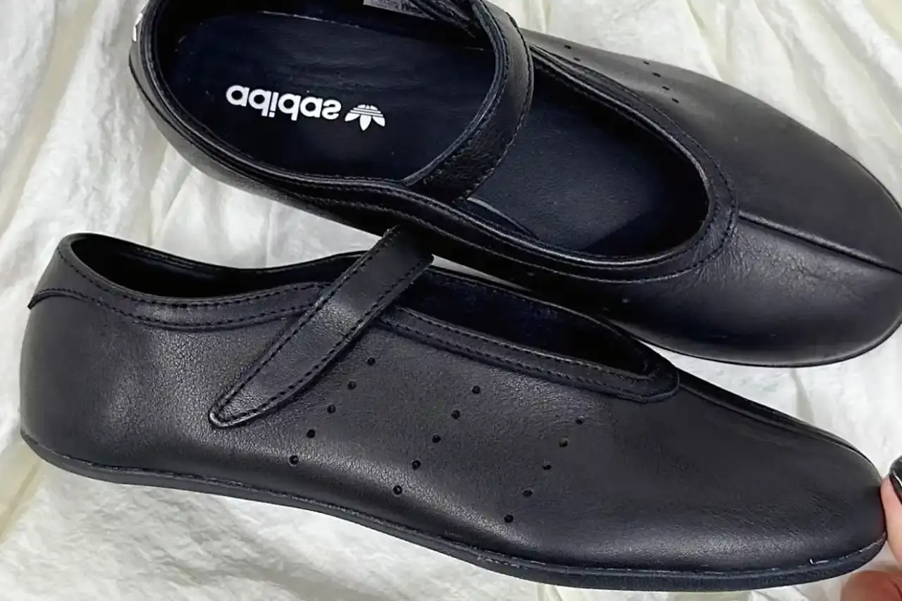 image about leaked photographs of upcoming adidas Stan Smith Ballet shoe featuring flat sole construction, minimalist design elements, single leather strap closure system, and expected summer 2025 release in black and white colorway options.