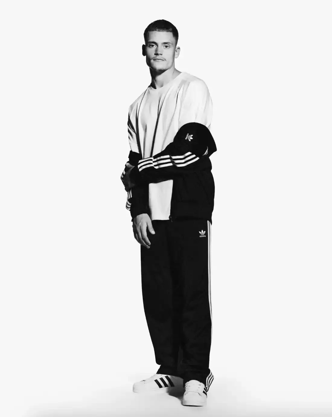 ADIDAS SUPERSTAR CAMPAIGN STARS STORMZY, BELLINGHAM, KEOGHAN image covers Adidas campaign featuring celebrities wearing iconic Superstar sneakers and Firebird tracksuits in black and white photography. (image 15 of 18)