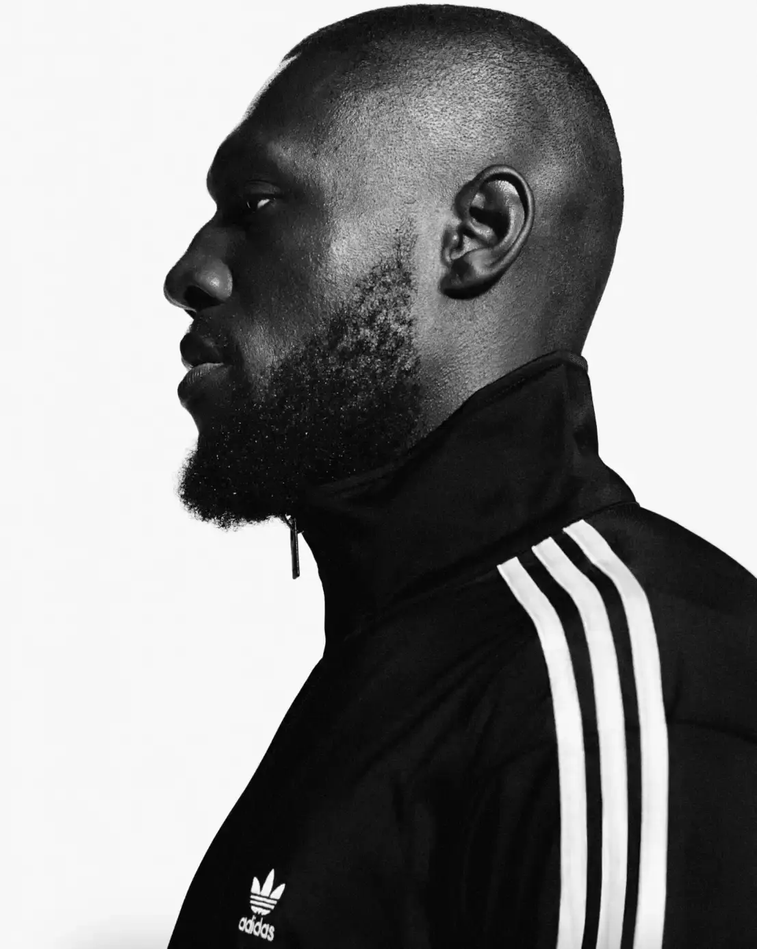 ADIDAS SUPERSTAR CAMPAIGN STARS STORMZY, BELLINGHAM, KEOGHAN image covers Adidas campaign featuring celebrities wearing iconic Superstar sneakers and Firebird tracksuits in black and white photography. (image 2 of 18)