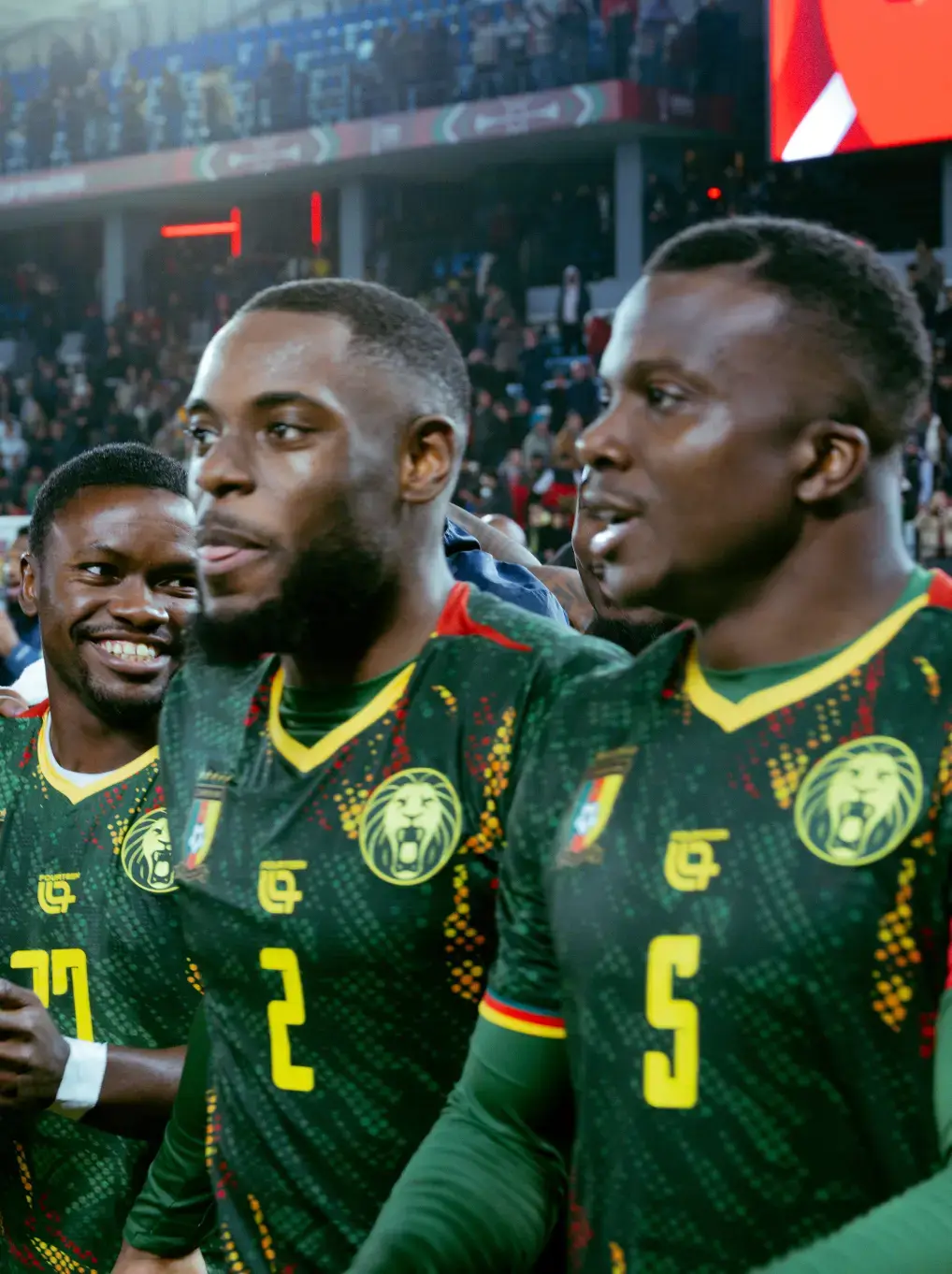 AFCON 2025 AND THE MOMENT FOOTBALL BECAME CULTURE Image photographs by Miguel the Colored Cowboy capture AFCON 2025 supporters in streets and stadiums. Images show clothing worn with purpose. Jerseys, tailored pieces, traditional fabrics, and sportswear appear across the frames. Faces show tension, pride, and focus. Clothing looks lived in. Scarves, jackets, and footwear respond to weather and movement. No staging. No distance. The gallery documents how style serves the moment during match days. Each image places viewers inside the crowd where expression stays personal and presence stays shared. (image 7 of 10)