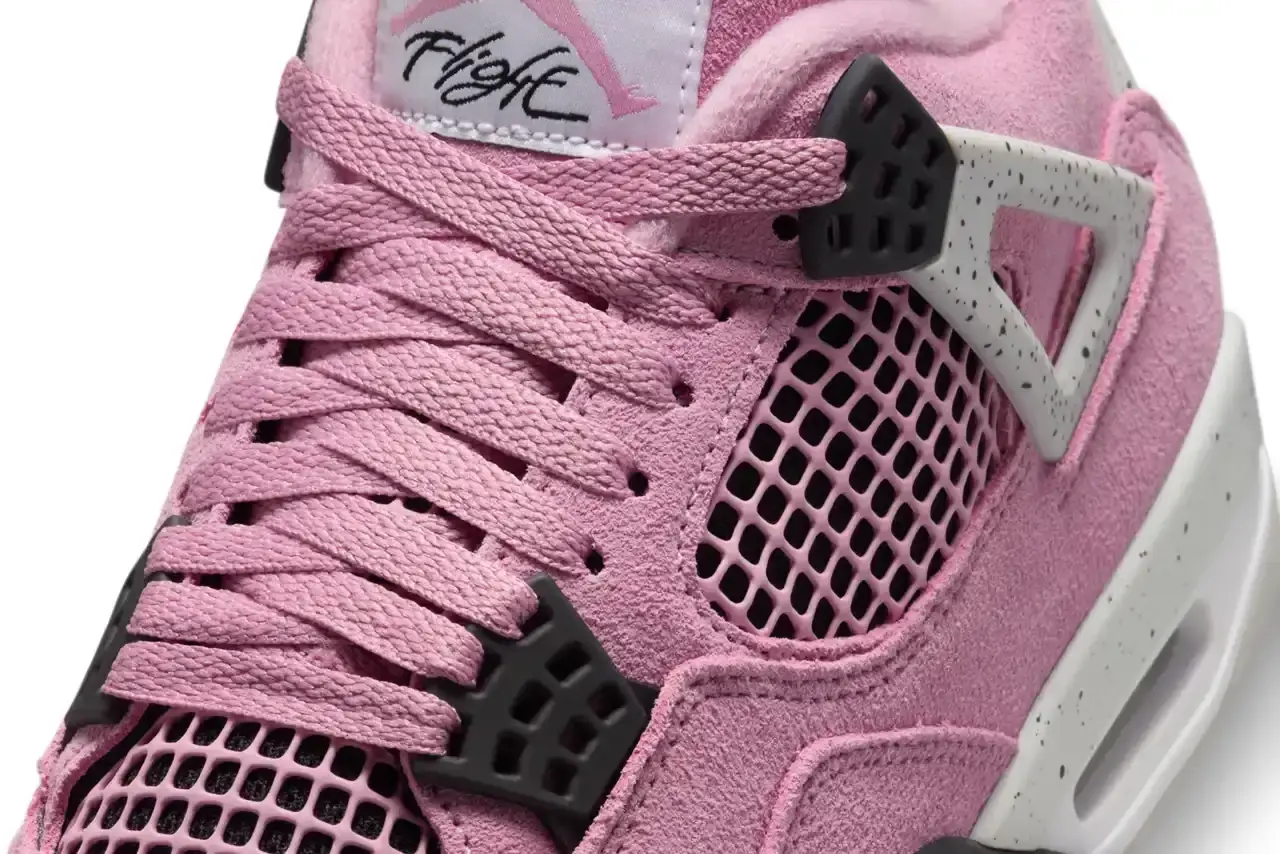 AIR JORDAN 4 "ORCHID" MAKES ITS DEBUT THIS WEEK Air Jordan 4 'Orchid' sneaker shown in three-quarter view, featuring pink suede upper with grey and black accents, white midsole, and signature AJ4 wing supports (image 6 of 7)