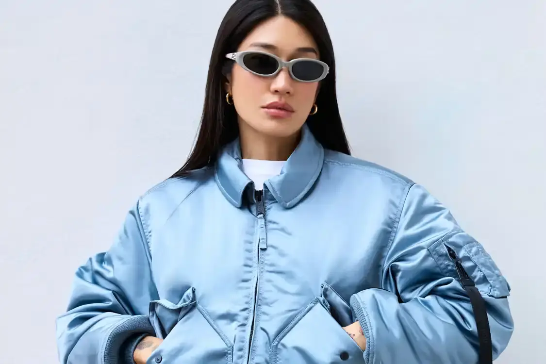 ALPHA INDUSTRIES X PEGGY GOU COLLECTION image about Alpha Industries and Peggy Gou's collaborative clothing collection, featuring bomber jackets and a versatile wrap skirt designed for transitioning between different environments.
