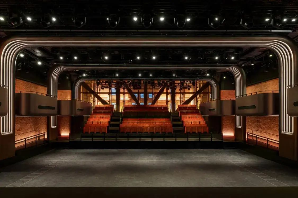 Overview of Apple Music Hall inside Battersea Power Station, detailing venue acoustics, broadcast control systems, and integrated recording studios.