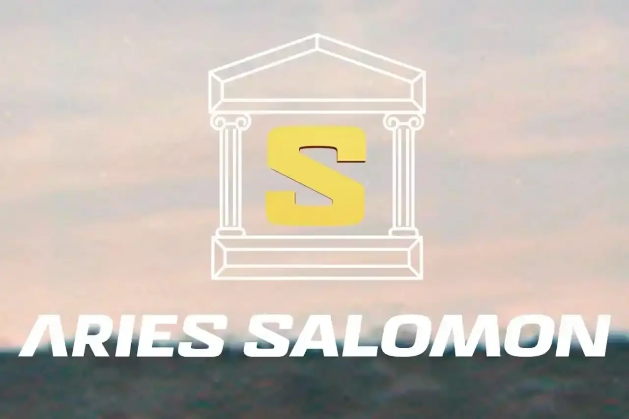 The article discusses a new collaboration between UK-based fashion label Aries and outdoor/athletic footwear brand Salomon. While details on the specific Salomon model are limited, the partnership continues Aries' footwear focus and Salomon's expanding list of collaborations with fashion and lifestyle brands.
