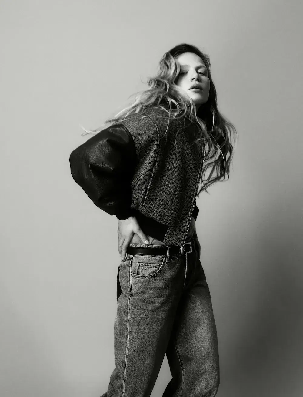 ARMANI EXCHANGE RELAUNCHES BASICS CAMPAIGN Black and white portrait photography from the Armani Exchange Basics campaign set against a neutral studio background. (image 14 of 16)