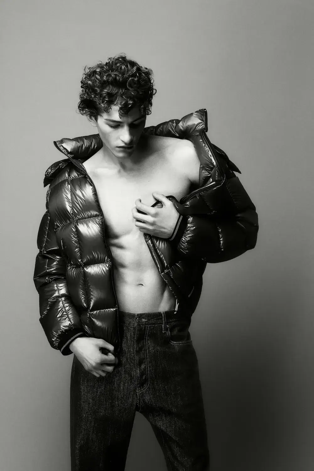 ARMANI EXCHANGE RELAUNCHES BASICS CAMPAIGN Black and white portrait photography from the Armani Exchange Basics campaign set against a neutral studio background.