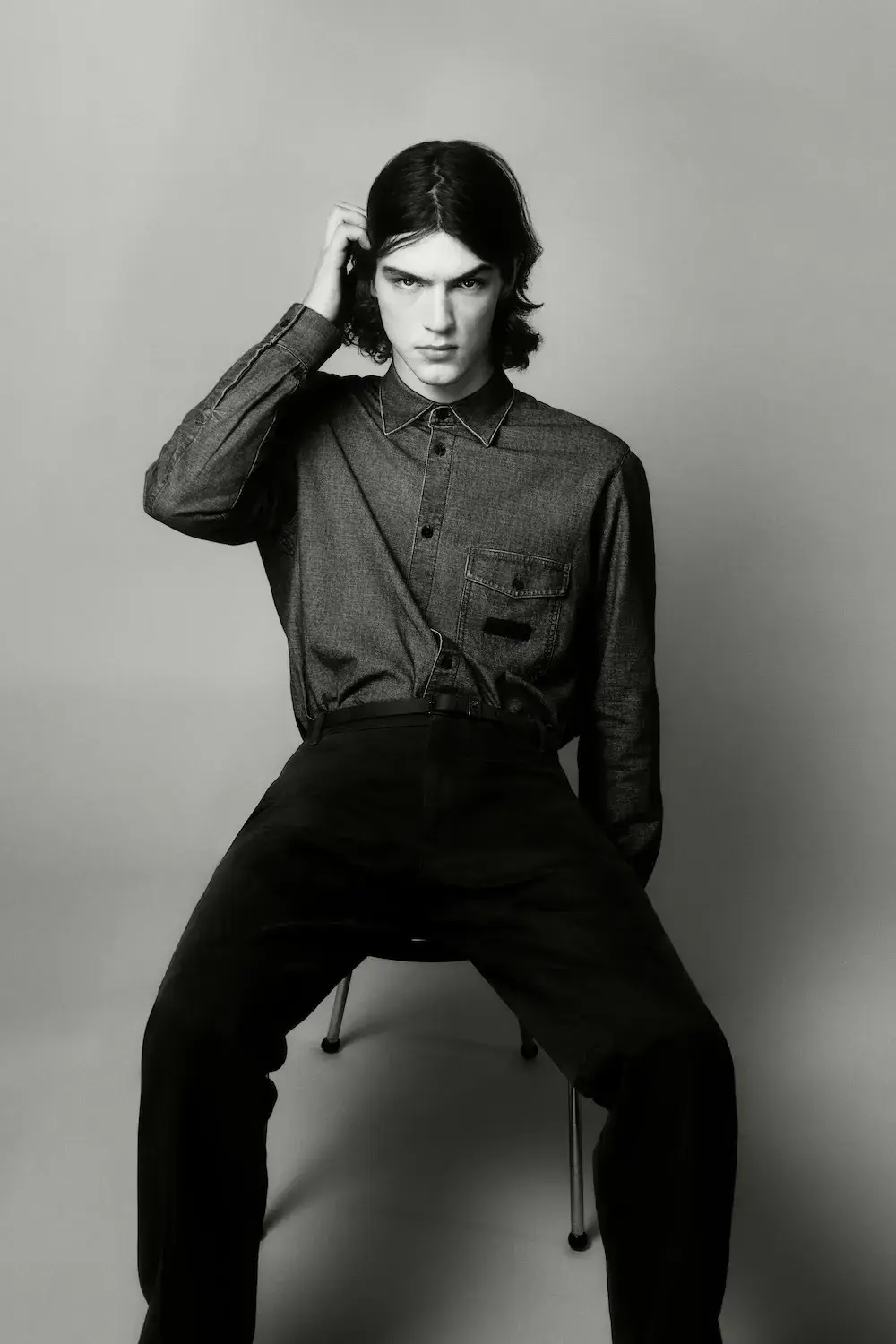 ARMANI EXCHANGE RELAUNCHES BASICS CAMPAIGN Black and white portrait photography from the Armani Exchange Basics campaign set against a neutral studio background. (image 7 of 16)