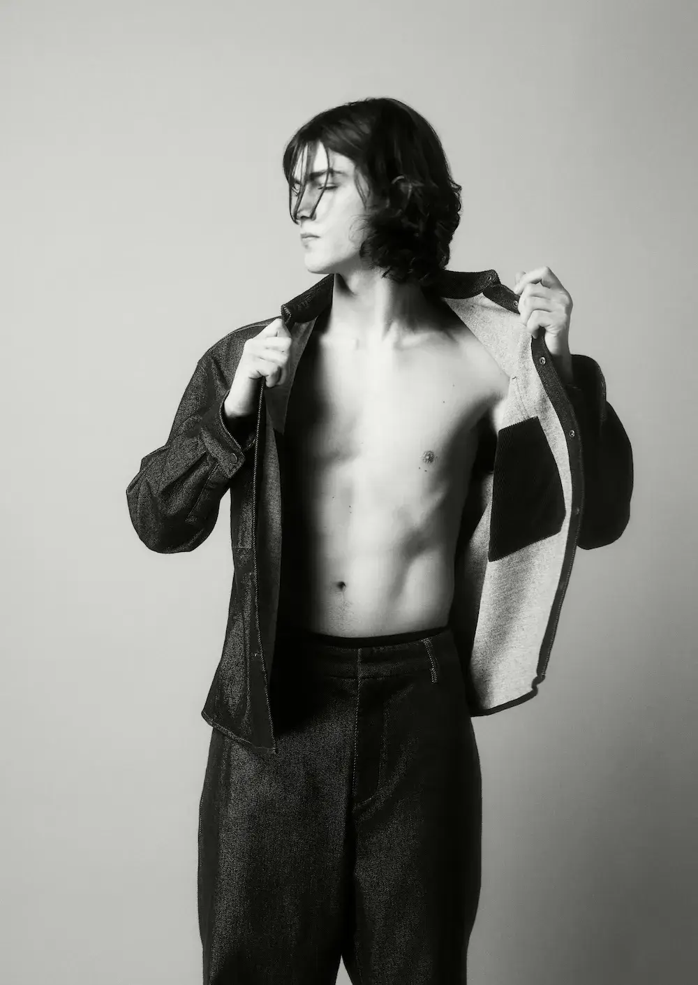 ARMANI EXCHANGE RELAUNCHES BASICS CAMPAIGN Black and white portrait photography from the Armani Exchange Basics campaign set against a neutral studio background. (image 4 of 16)