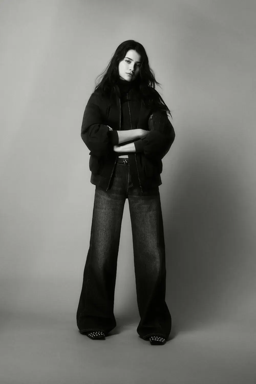 ARMANI EXCHANGE RELAUNCHES BASICS CAMPAIGN Black and white portrait photography from the Armani Exchange Basics campaign set against a neutral studio background. (image 15 of 16)