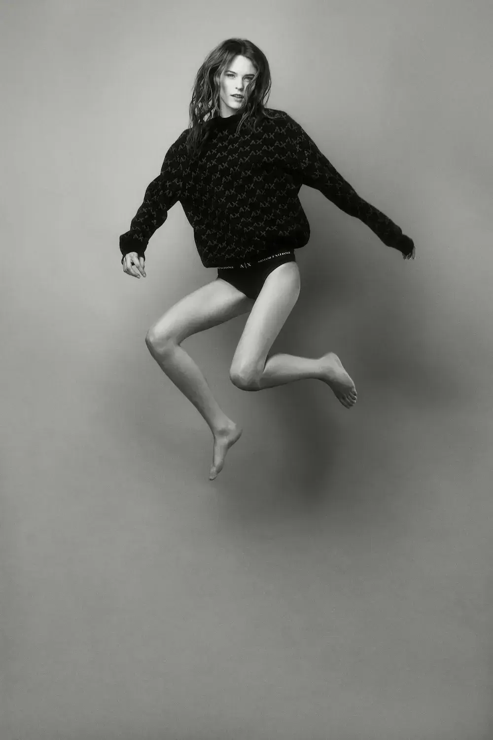 ARMANI EXCHANGE RELAUNCHES BASICS CAMPAIGN Black and white portrait photography from the Armani Exchange Basics campaign set against a neutral studio background. (image 16 of 16)