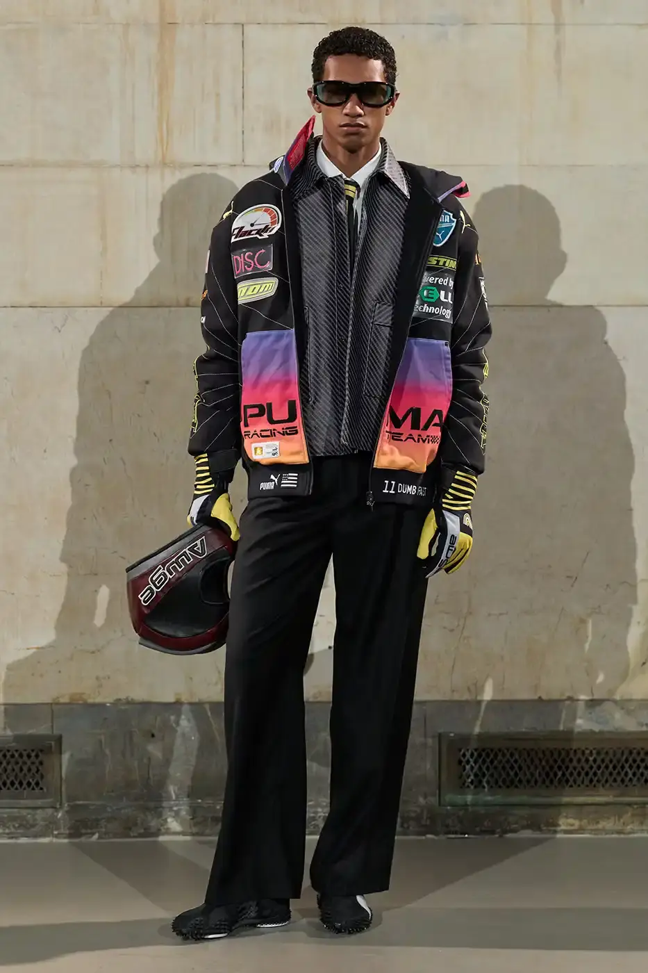 A$AP ROCKY TURNS BACKSTAGE INTO RUNWAY AT NYFW AWGE presented its Fall/Winter 2026 collection at New York Fashion Week with models receiving hair and makeup on the runway. The show featured baby carriers, motorsport aesthetics, and new A$AP Rocky x PUMA footwear releases. (image 23 of 41)