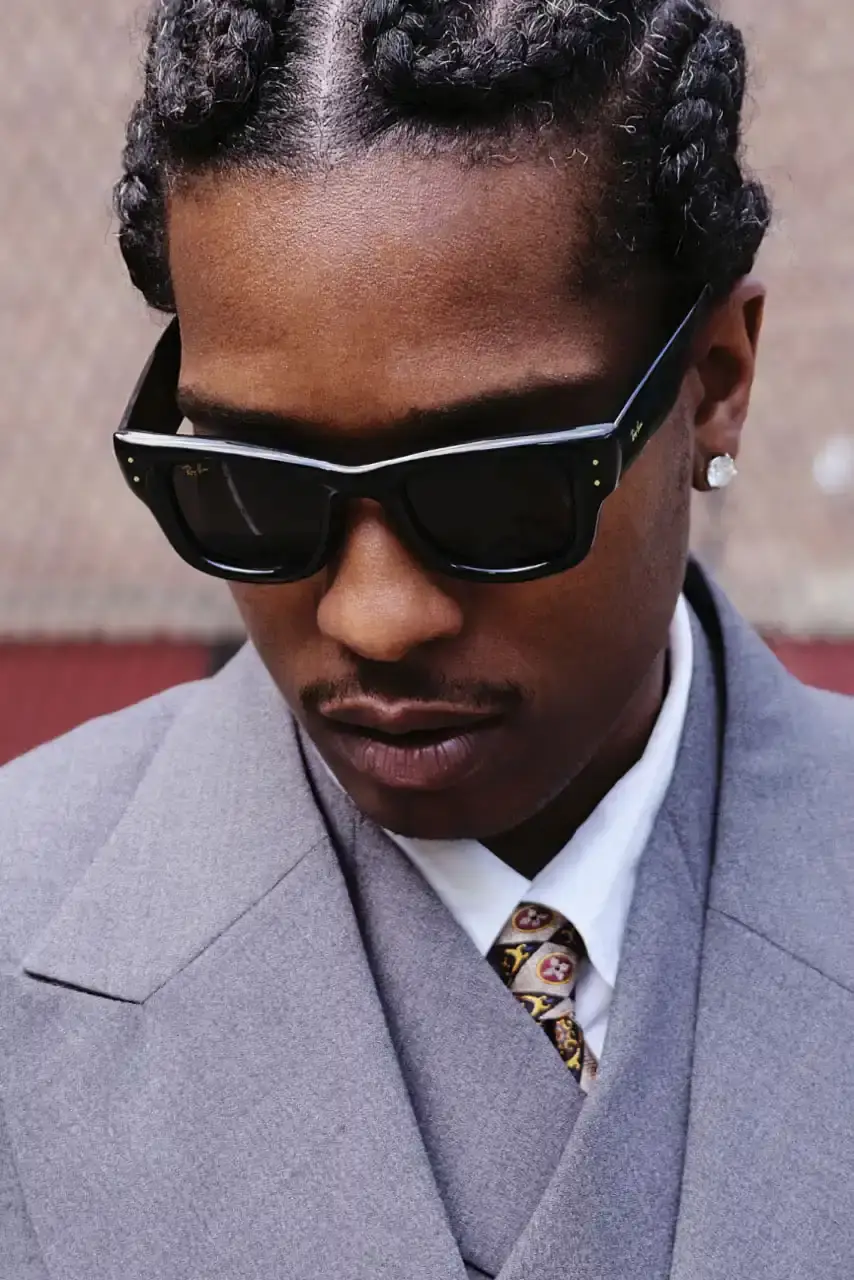 ROCKY UNVEILS RAY-BAN WAYFARER PUFFER COLLECTION image about A$AP Rocky's new Ray-Ban sunglasses collection. The Wayfarer Puffer frames come in seven colors and cost $202 each. The advertising campaign was photographed in Harlem using local residents as models. Rocky became Ray-Ban's Creative Director in February and previously wore custom versions of these sunglasses to the Met Gala and Cannes Film Festival. (image 4 of 10)