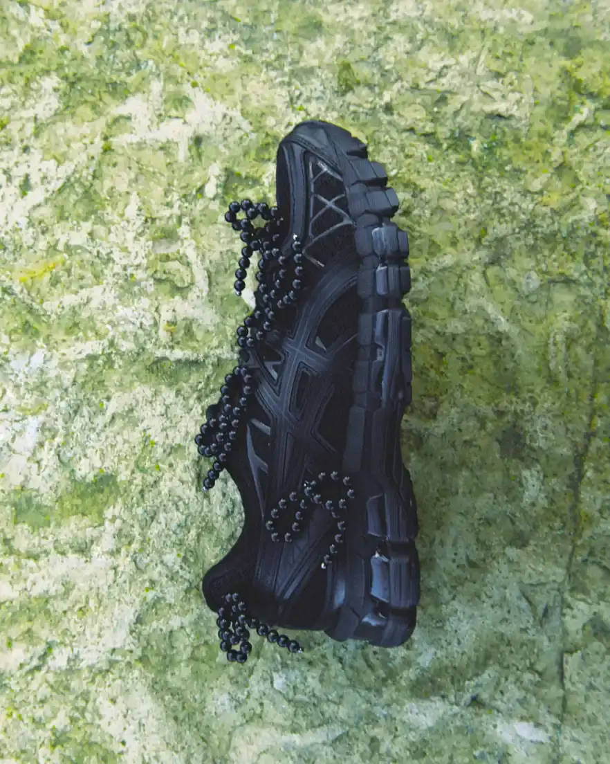 ASICS AND COMPLETEDWORKS RELEASE GEL-KAYANO 20 COLLABORATION A photograph shows a pair of ASICS GEL-KAYANO 20 sneakers modified with sculptural jewelry elements like pearls and floral motifs. (image 6 of 6)