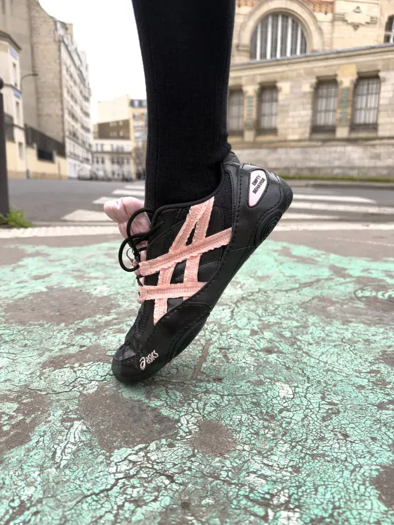 ASICS AND EMPTY BEHAVIOR LAUNCH HYPERSYNC SNEAKER An image showing the low-profile ASICS x EMPTY BEHAVIOR HYPERSYNC sneaker on Paris streets, featuring ruffled fabric overlays on the side stripes. (image 6 of 8)