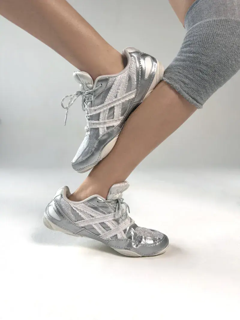 ASICS AND EMPTY BEHAVIOR LAUNCH HYPERSYNC SNEAKER An image showing the low-profile ASICS x EMPTY BEHAVIOR HYPERSYNC sneaker on Paris streets, featuring ruffled fabric overlays on the side stripes. (image 4 of 8)