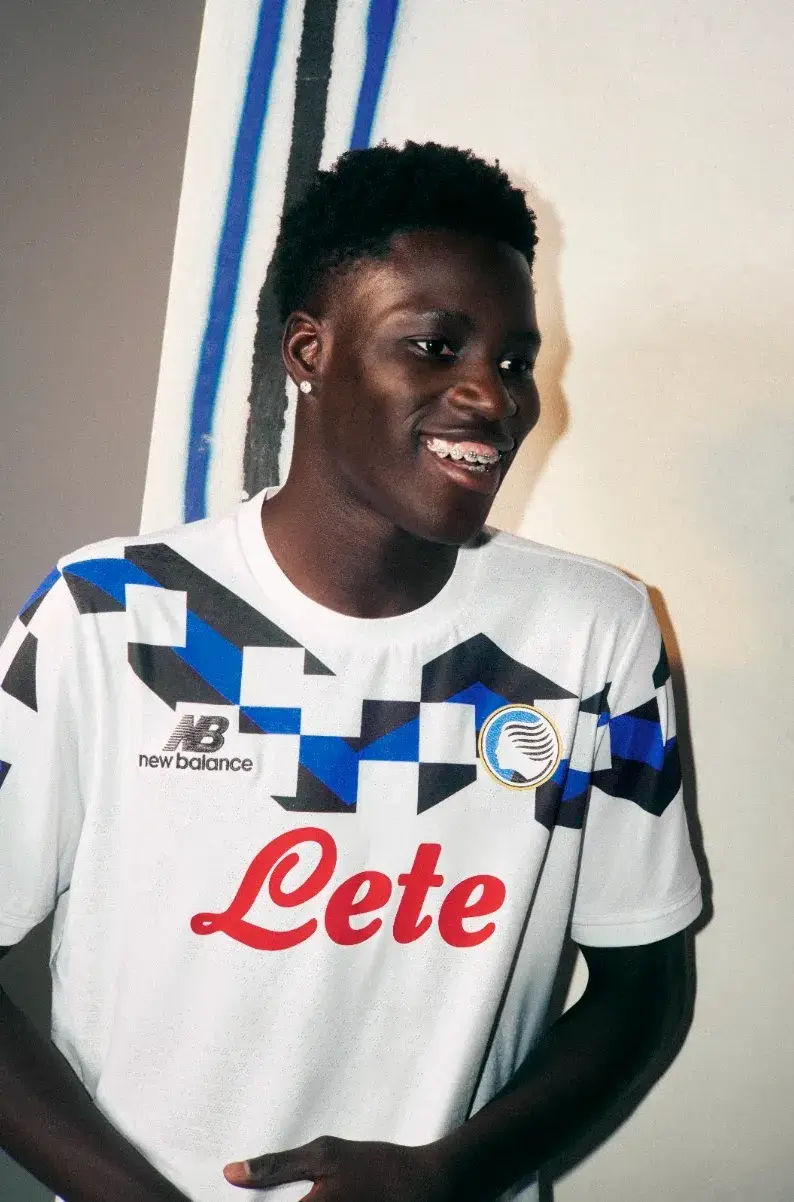 ATALANTA BC 2026 AWAY KIT BY NEW BALANCE image of the Atalanta BC 2026/27 New Balance white away jersey with black and Oasis Blue geometric accents. (image 2 of 3)