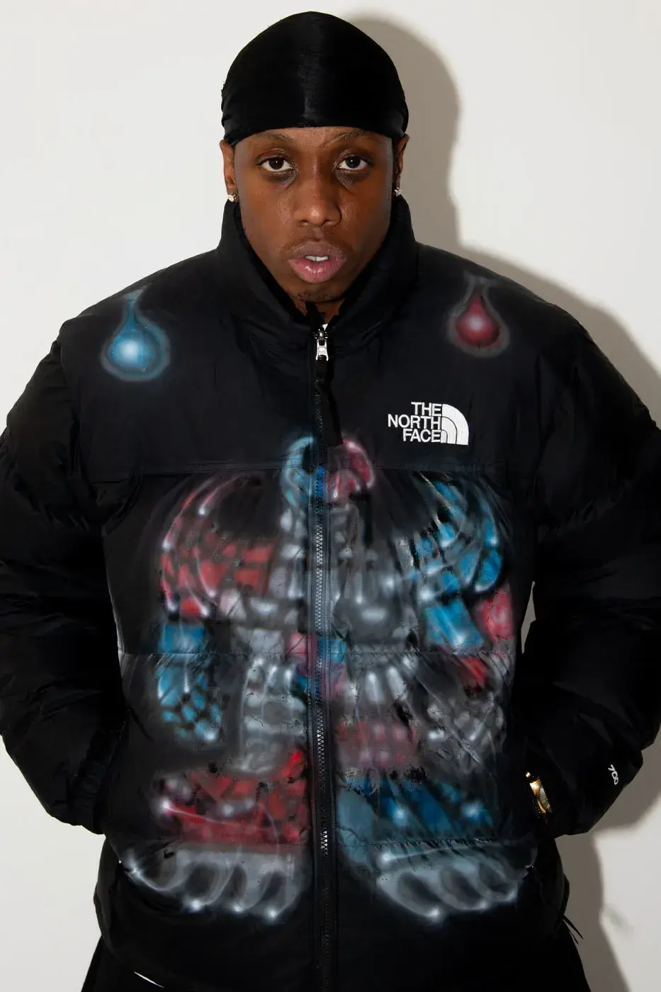 AWAKE NY AND THE NORTH FACE RELEASE 50 CUSTOM NUPTSE JACKETS image of Awake NY and The North Face made 50 hand-customized Nuptse jackets with artists Omi and Alehsy Lambo. Part of the run goes on sale on the Awake NY website on Monday, October 19, 2026, at 1 p.m. (image 5 of 10)
