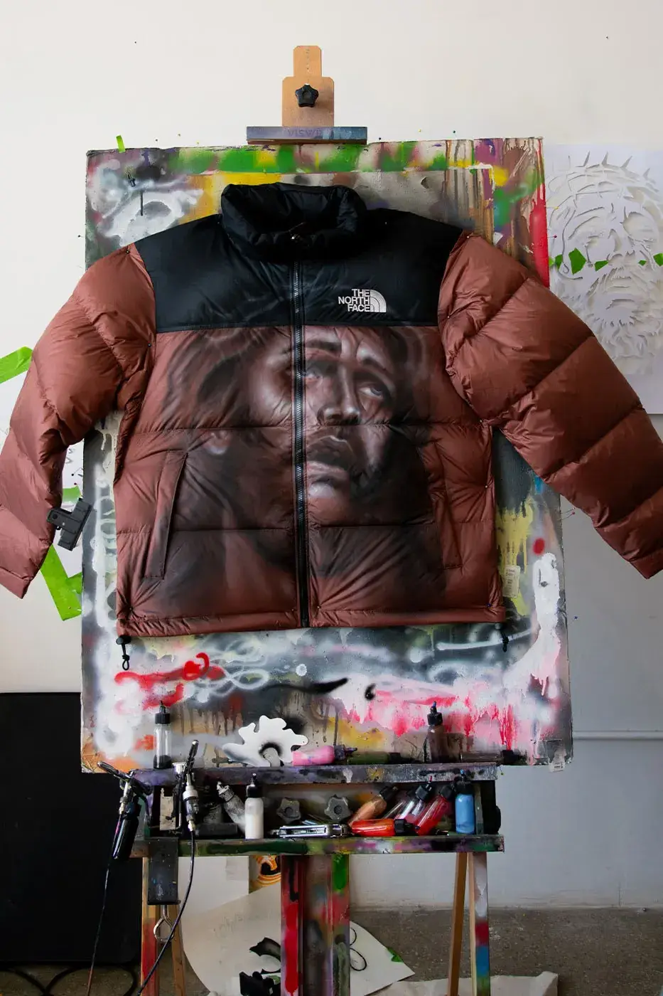 AWAKE NY AND THE NORTH FACE RELEASE 50 CUSTOM NUPTSE JACKETS image of Awake NY and The North Face made 50 hand-customized Nuptse jackets with artists Omi and Alehsy Lambo. Part of the run goes on sale on the Awake NY website on Monday, October 19, 2026, at 1 p.m. (image 10 of 10)