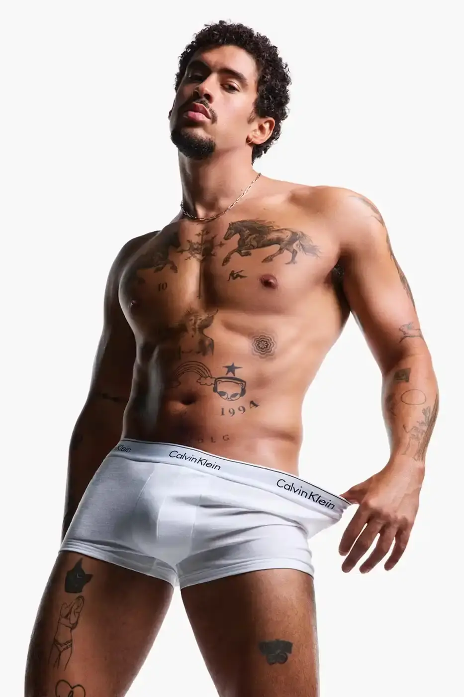 Calvin Klein Bad Bunny wearing Calvin Klein underwear from the Icon Cotton Stretch line, photographed in Puerto Rico. (image 3 of 5)