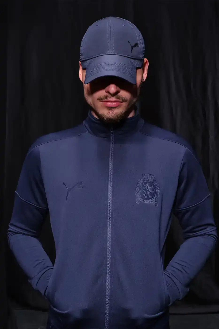 Balenciaga Balenciaga x PUMA collection display showing the Ultrasoft Speedcat sneakers in three colorways alongside tracksuits, outerwear pieces, and accessories arranged on a neutral background. (image 19 of 21)