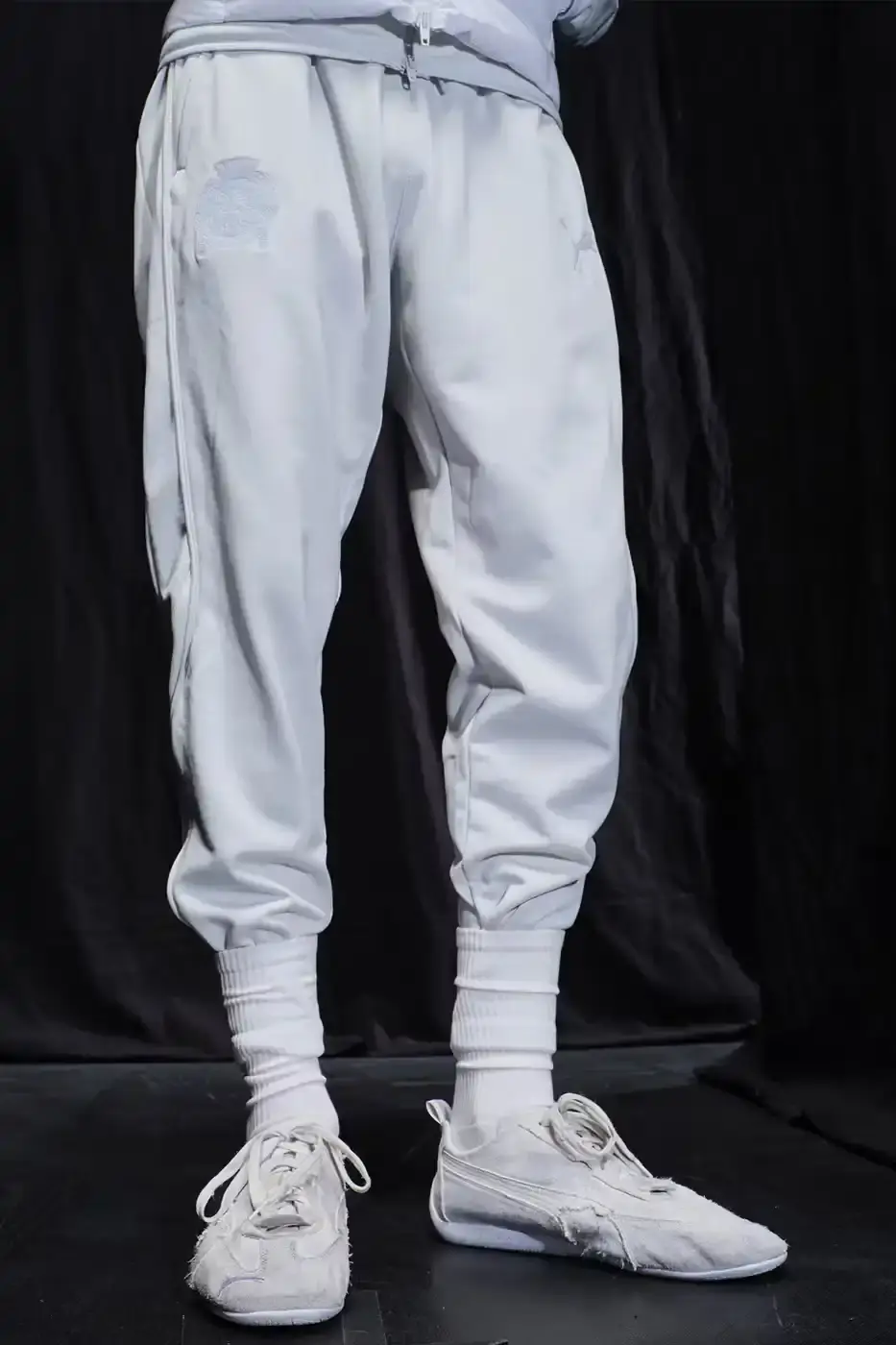 Balenciaga Balenciaga x PUMA collection display showing the Ultrasoft Speedcat sneakers in three colorways alongside tracksuits, outerwear pieces, and accessories arranged on a neutral background. (image 6 of 21)