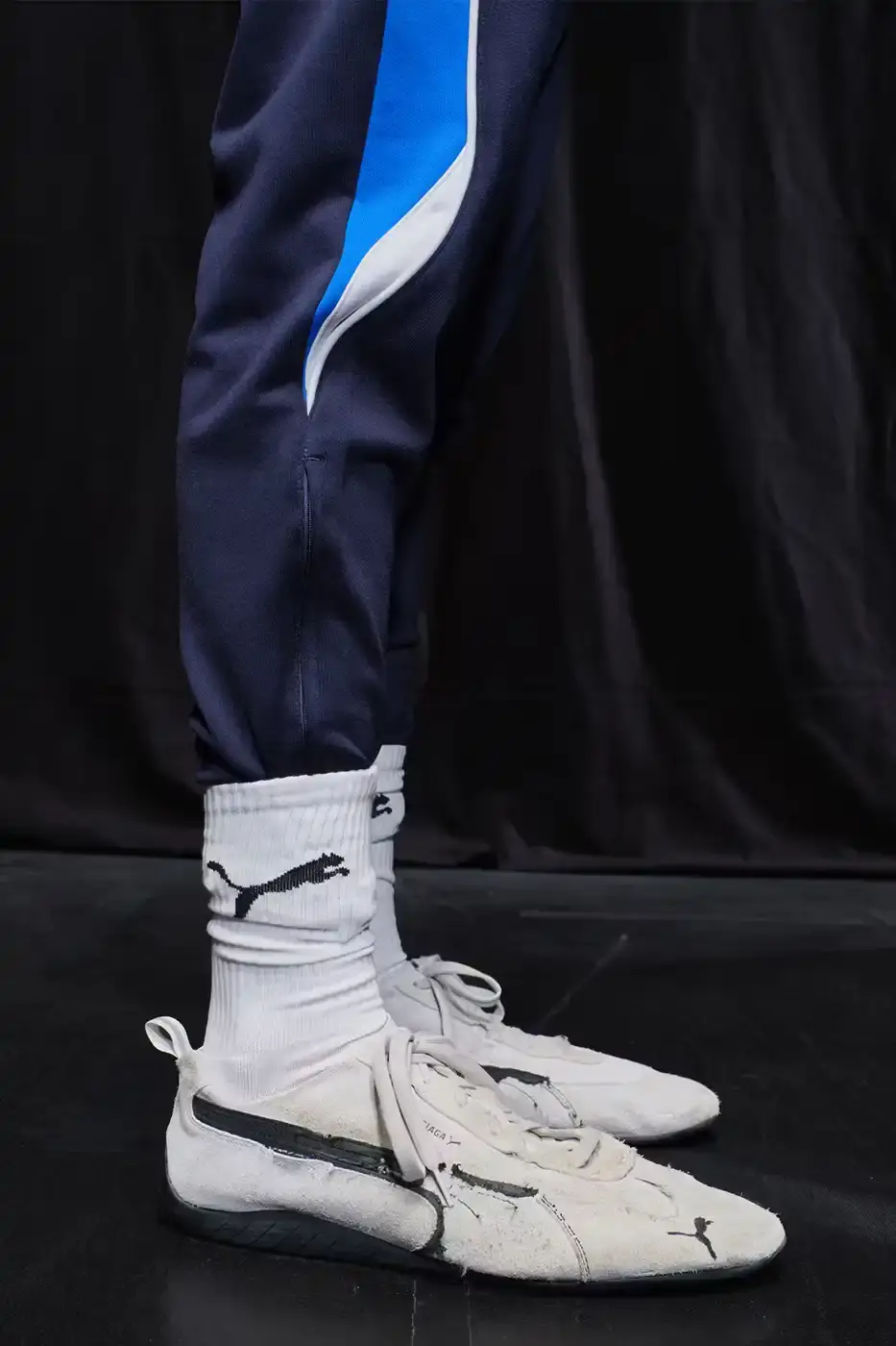 Balenciaga Balenciaga x PUMA collection display showing the Ultrasoft Speedcat sneakers in three colorways alongside tracksuits, outerwear pieces, and accessories arranged on a neutral background. (image 14 of 21)