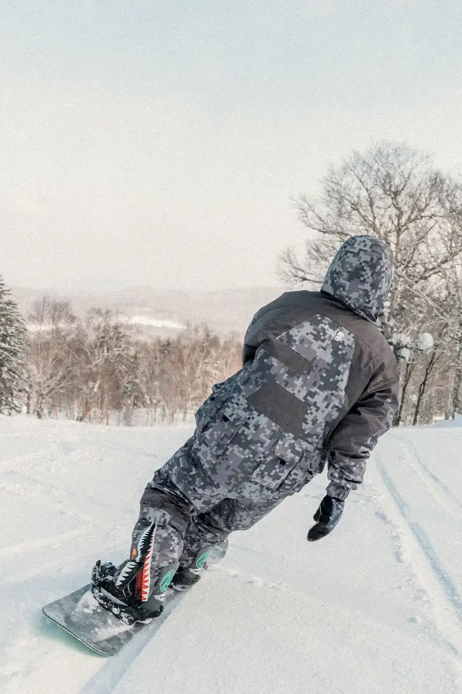 BAPE RELEASES FINAL PAW WINTER COLLECTION BAPE releases third Performance All Weather collection featuring technical snowboard jackets, overalls, and accessories with new camouflage patterns designed for extreme winter conditions. (image 2 of 24)