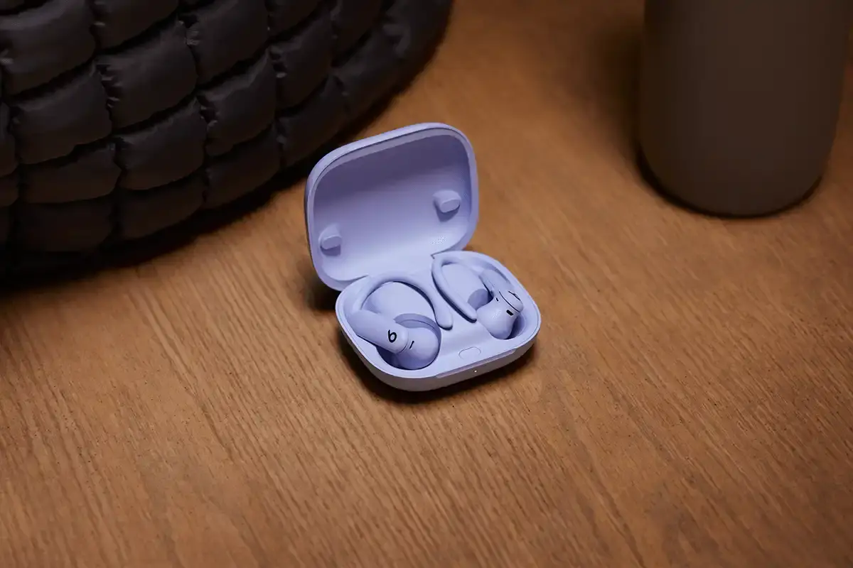 Beats Powerbeats Pro 2 wireless earphones in Electric Purple color, showing ear hooks and charging case with wireless charging capability. (image 6 of 8)
