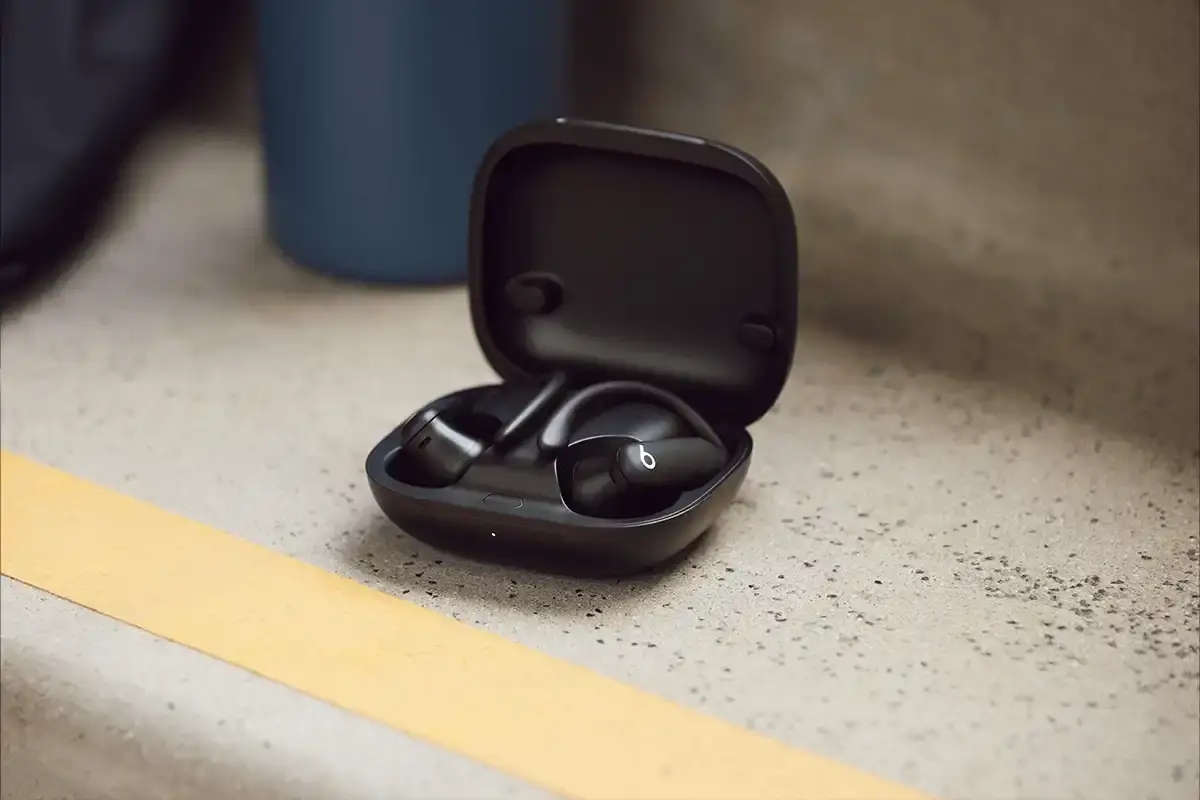 Beats Powerbeats Pro 2 wireless earphones in Electric Black color, showing ear hooks and charging case with wireless charging capability.