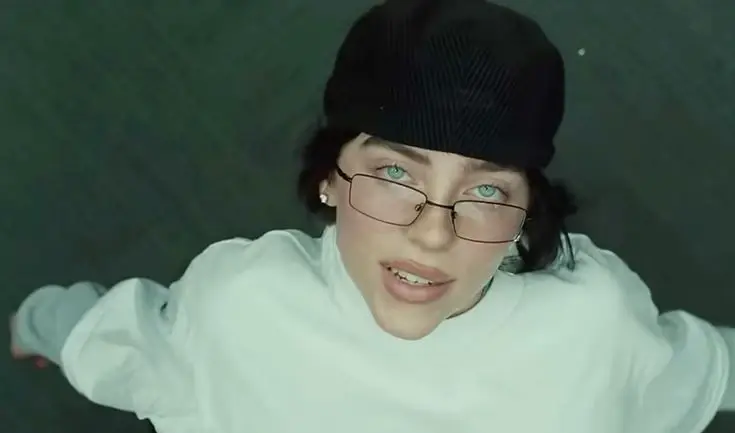 Article about Billie Eilish's song 'BIRDS OF A FEATHER' becoming Spotify's most-streamed track of 2024, with details about streaming numbers, Billboard performance, and upcoming tour dates.