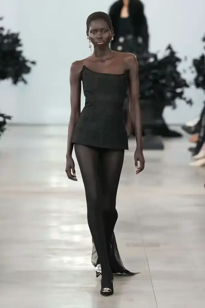 Blumarine - Fall-Winter2025 - 2026 - Womenswear - Italie - Milan - ©Launchmetrics/spotlight Models walking the runway at David Koma's debut Blumarine autumn/winter 2025 collection, showcasing sculptural neoprene pieces and bustier dresses in a palette of red, black, gray, and white against a minimalist backdrop at Milan Fashion Week. (image 19 of 20)