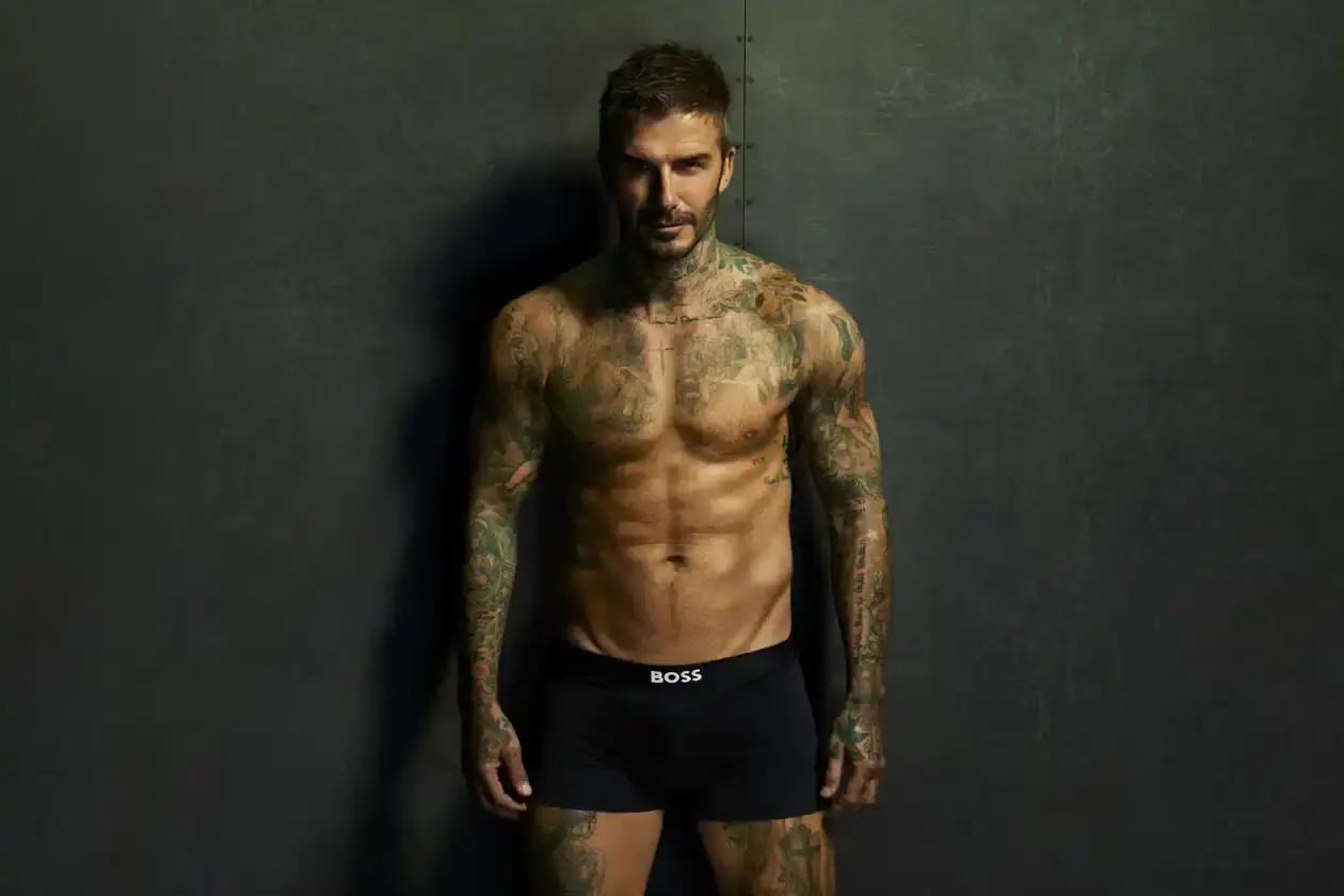 Boss David Beckham wearing white BOSS ONE boxer briefs while seated in a minimalist New York apartment, photographed in black and white (image 2 of 5)