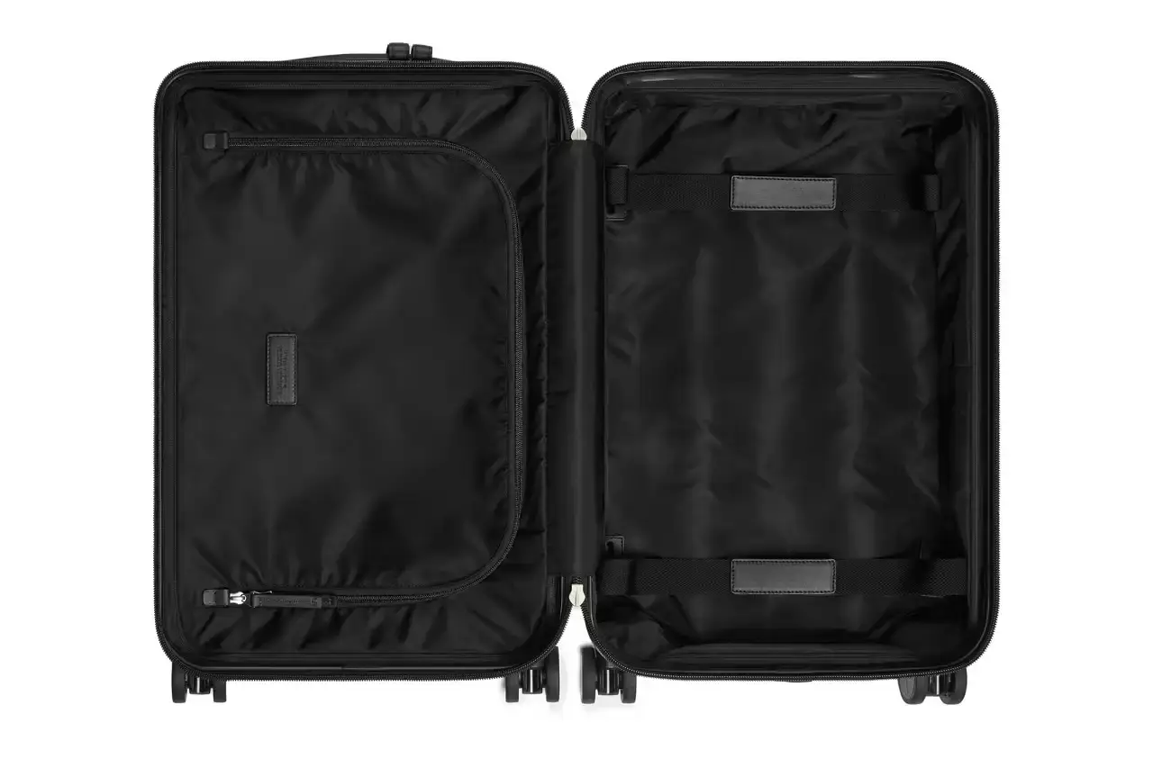 Bottega Veneta Bottega Veneta Odyssey carry-on suitcase with textured polycarbonate shell featuring 3D Intreccio pattern, silver hardware, and brown calfskin leather handles. The wheeled luggage is shown in a three-quarter view displaying its structured design and branded details. (image 3 of 7)